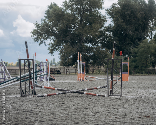 Empty field for horse jumping event competition. Colorful photo of equestrian obstacles.