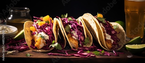 Tacos with fish mango salsa red cabbage salmon beer and hot honey copy space image photo