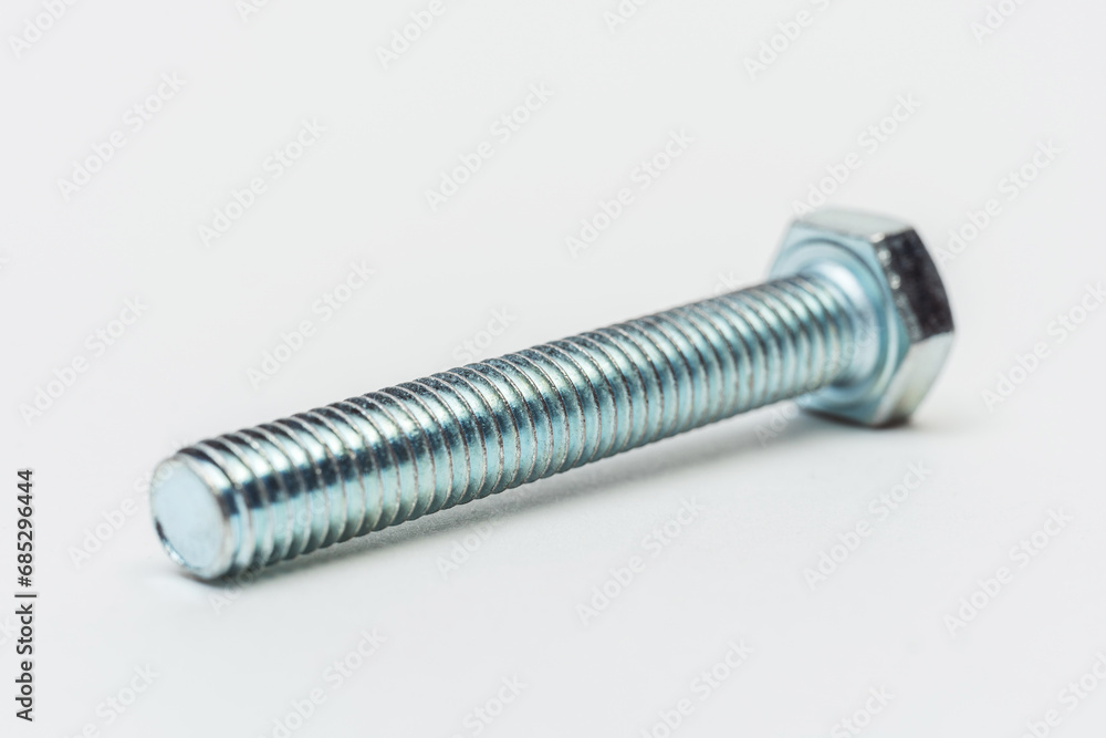 iron bolt on a white background. metal bolt on a light background. photos of a threaded bolt for the catalog iron bolt on a white background. metal bolt on a light background. photos of a threaded bolt for the catalog