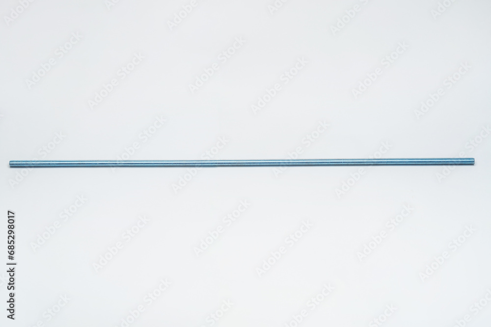 iron threaded stud on a white background. metal rod with thread on a light background. construction long bolt with thread for fastening - obrazy, fototapety, plakaty 