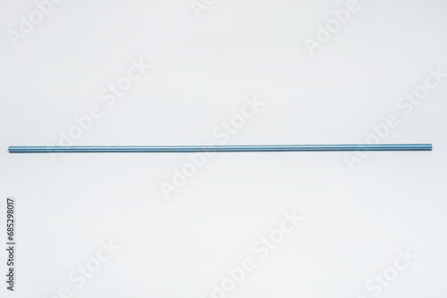 iron threaded stud on a white background. metal rod with thread on a light background. construction long bolt with thread for fastening photo