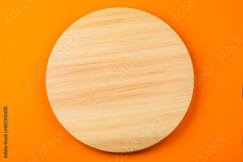Wooden round board on the table