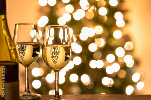 two glass of wine in front of the christmas tree photo