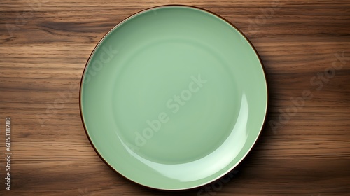 Top View of an empty Plate in light green Colors on a wooden Table. Elegant Template with Copy Space