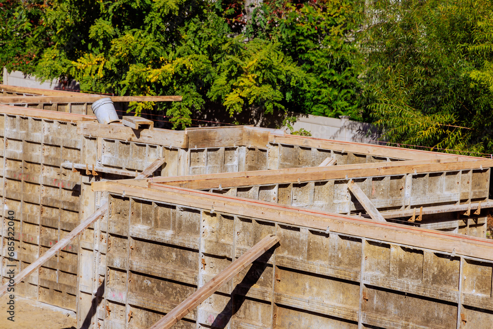 Building house foundation requires assembly of metal formwork Building house foundation requires assembly of metal formwork