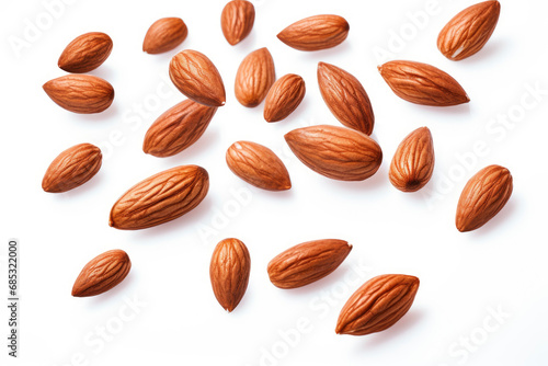 Almonds fall in pile on white background. Creative concept of floating healthy snacks. Background of falling almonds. Levitation of nuts. Close-up. Copy space.