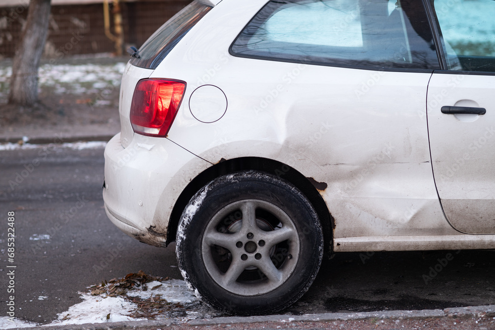 Car body side damage, traffic accident in winter season. Car damage, broken and damaged
