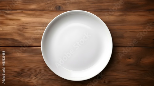 Top View of an empty Plate in white Colors on a wooden Table. Elegant Template with Copy Space