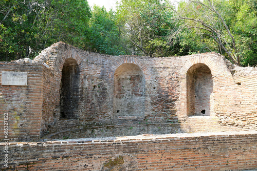 Ruins of the Great Basilica in Butrint National Park, Buthrotum, Albania. Triconch Palace at Butrint Life and death of an ancient Roman house Historical medieval Venetian Tower surrounded photo