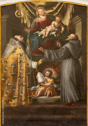 VICENZA, ITALY - NOVEMBER 5, 2023: The  baroque painting of Madonna with the sanits n the church Chiesa di San Gaetano by unknown artist. photo