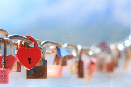 Old red heart shaped lock. Love lock on the bridge.  Red love padlock. Valentines day, unity, memory concepts.