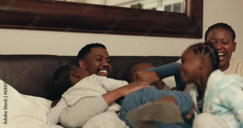Black family, funny children with mom and dad in bed for playing or laughing in the morning together. Happy parents and kids in the bedroom for love, comedy or bonding while in their home to relax Black family, funny children with mom and dad in bed for playing or laughing in the morning together. Happy parents and kids in the bedroom for love, comedy or bonding while in their home to relax
