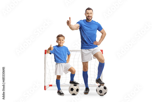 Man and boy in front of a goal gesturing thumbs up © Ljupco Smokovski