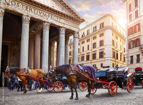 Rome, Italy. Horses in harness with coach for entertaining touristic strolls and city tours at Rotunda square (Piazza della Rotonda) front of Pantheon ancient roman building columns. Pantheon. © Yasonya