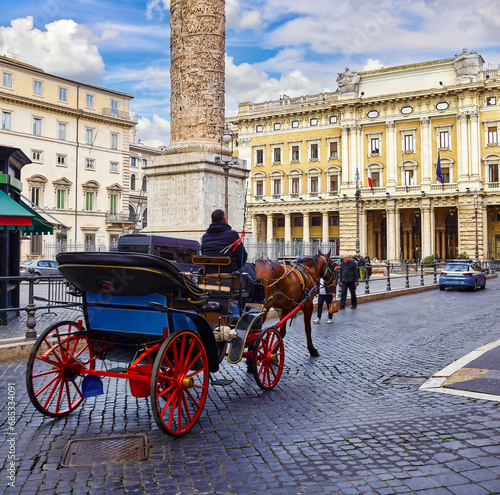 Rome, Italy. Horses in harness with coach for entertaining touristic strolls and city tours at Piazza Colonna (Rione of Column Marcus Aurelius, ancient roman column the Rome center