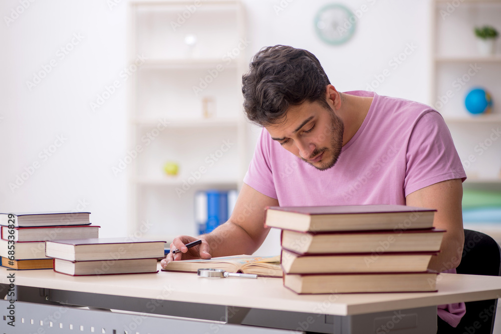 Young male student sitting in the classroom Young male student sitting in the classroom