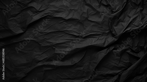 Black crumpled paper texture in low light background