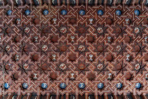 Flat view of decorated ceiling of cloister's corridor of Monastery of Saint John of the Kings in mudejar style, in Toledo, Spain photo