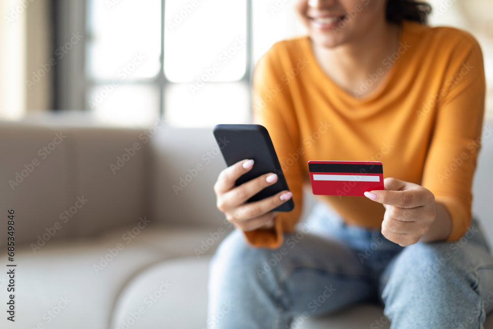 Mobile Payments. Smiling Woman Using Smartphone And Credit Card At Home, Closeup Mobile Payments. Smiling Woman Using Smartphone And Credit Card At Home, Closeup