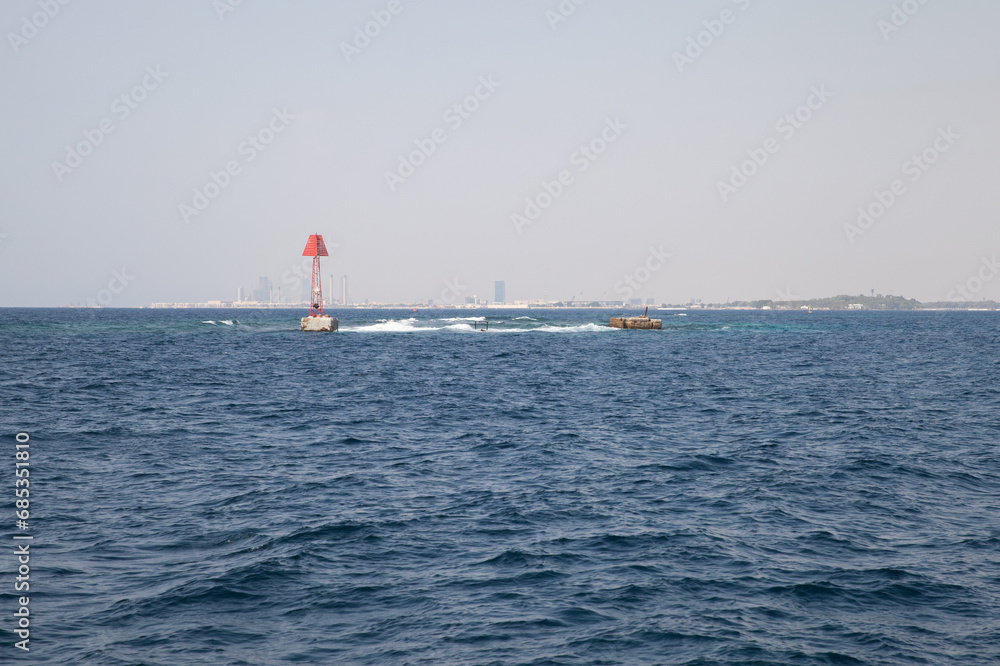 Red beacon tower is marking the border of a fairway to Jeddah Islamic Seaport