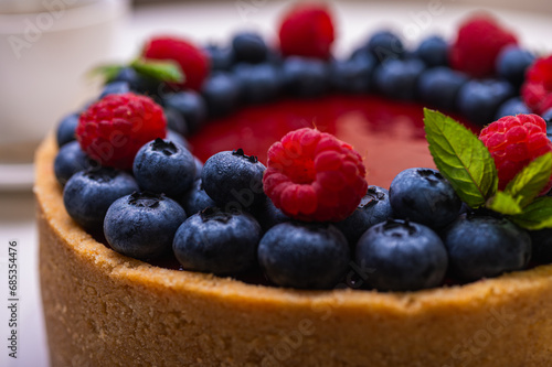 cheese cheesecake close-up view decorated with fresh berries, blueberries and raspberries