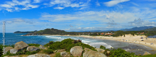 landscape withPanoramic view of Barra Garopaba beach, with rocks at the top of the viewpoint in the foreground. lake