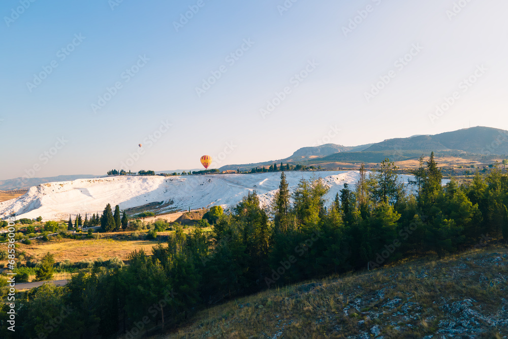 Aerial view of Pamukkale Travertine with hot air balloon are flying above tourism area