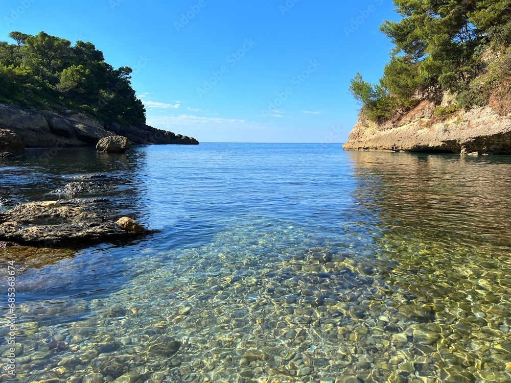 Sea pebble beach clear water rocky coast of Montenegro 