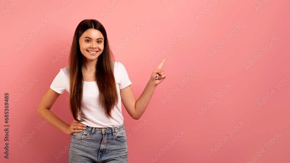 Check This. Happy Teen Girl Pointing Aside At Copy Space With Finger Check This. Happy Teen Girl Pointing Aside At Copy Space With Finger