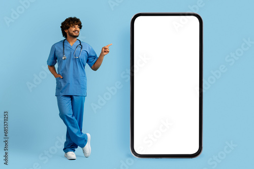 Doctor wearing medical uniform pointing at big phone
