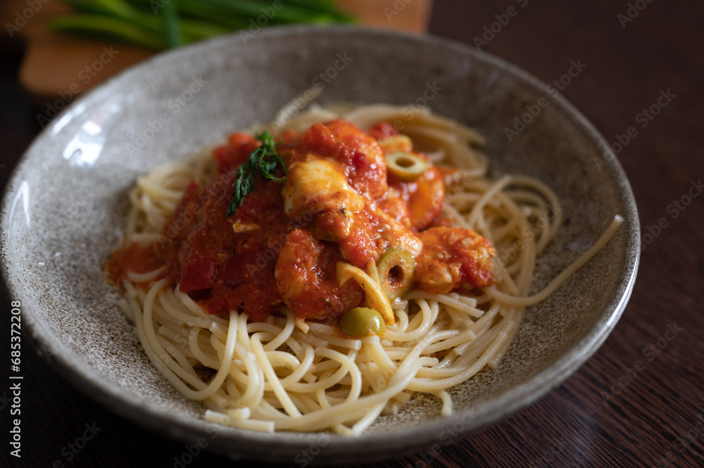 Spaghetti with tomato and olives sauce in a bowl Spaghetti with tomato and olives sauce in a bowl