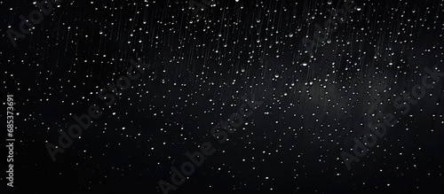 Random raindrops and white specks on black backdrop photo