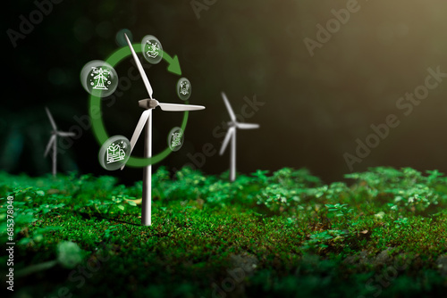 Wind turbines that are in harmony with nature With the forest as the background, Icon of the concept of using clean energy, campaigning for the use of renewable energy that is environmentally friendly