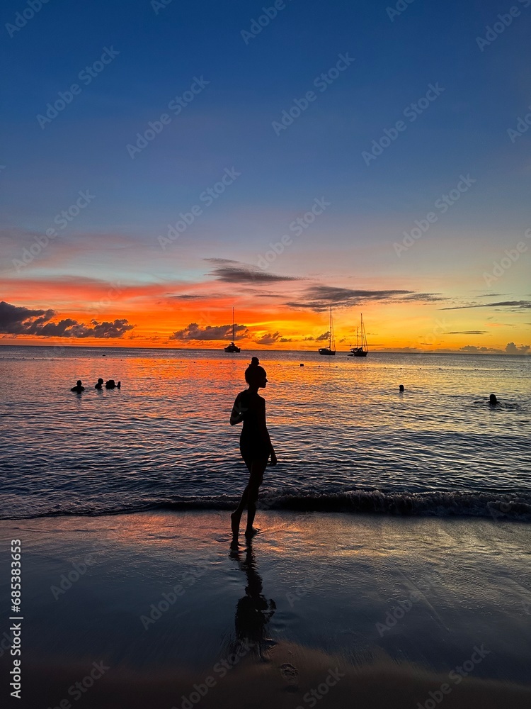 silhouette of a person on the beach at sunset