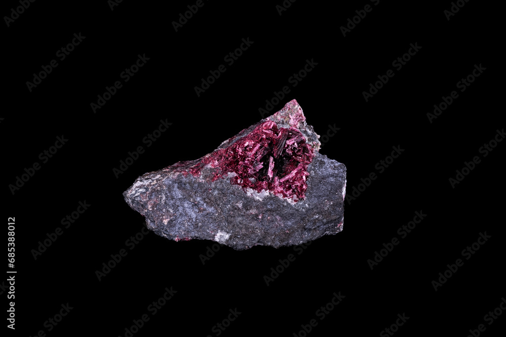 Erythrite crystals (also knwon as red cobalt) isolated on black background. macro detail close-up rough raw unpolished semi-precious gemstone.
