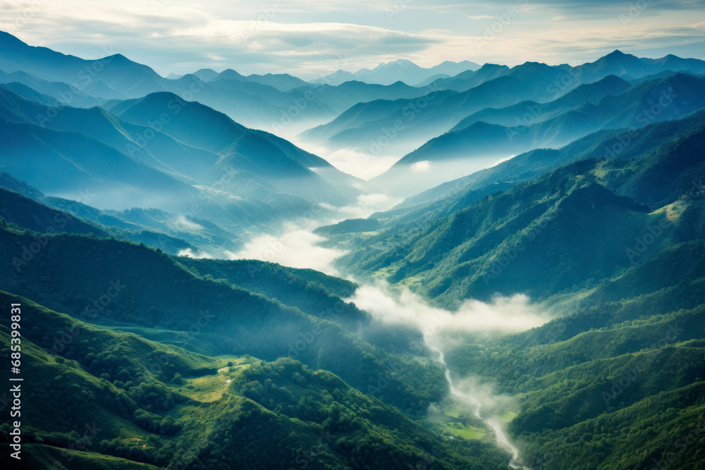 A lush mountain range photographed from above, showcasing the majestic peaks, valleys, and winding rivers.