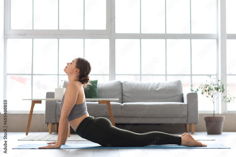 Sporty young woman doing yoga at home Sporty young woman doing yoga at home
