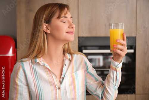 Young woman with glass of o...