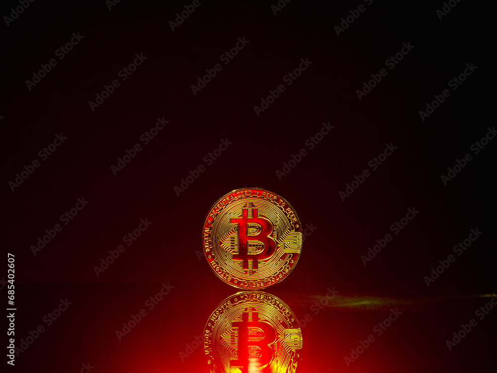 Golden bit coin on abstract dangerous red electric background. Finance and banking concept. Modern technology. Investing into digital money.