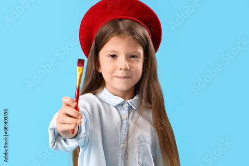 Young girl in red beret hol...