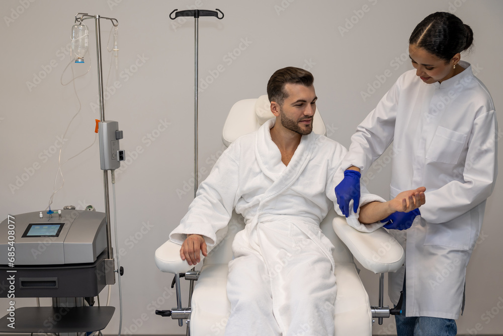 Fototapeta premium Man in modern wellness center during intravenous vitamin therapy.