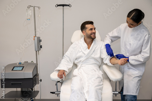Man in modern wellness center during intravenous vitamin therapy.