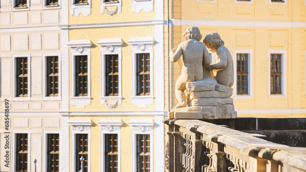 Cityscape - view of the sculpture of a pair of cupids against the backdrop of Dresden Castle close-up, Dresden, Saxony, Germany