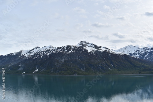Snowy mountains reflection in ocean