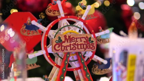 Festive ferris wheel with elves on sleighs in toy store carousel Close-up of colorful Merry Christmas Ferris wheel has fun rolling toys on sleigh in circle Enjoy beautiful Ferris wheel in store window photo