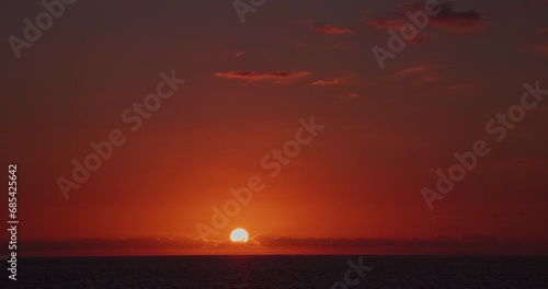 4K sunset dusk twilight evening magic hour clean sky orange glow. Ocean horizon and serene nightfall in a peaceful nature landscape. Realtime video footage