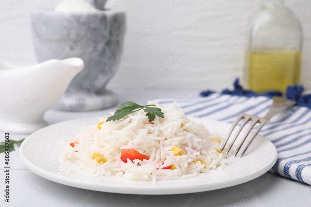 Delicious rice with vegetables and parsley served on table, closeup Delicious rice with vegetables and parsley served on table, closeup