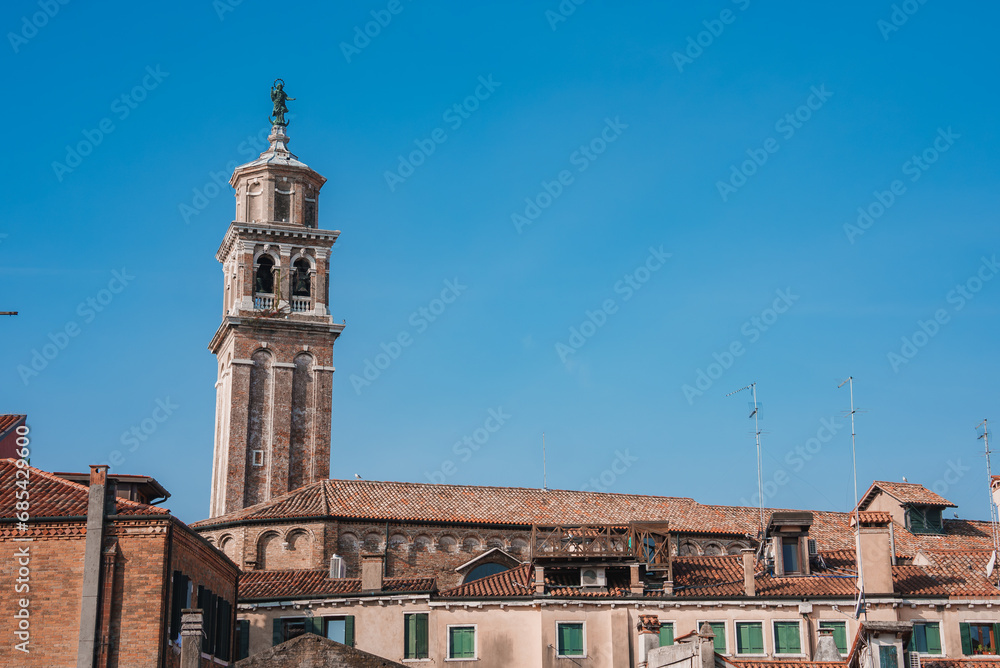 A photograph of a building with a clock tower, taken from an unknown angle and location. No specific landmarks or architectural details are visible. A photograph of a building with a clock tower, taken from an unknown angle and location. No specific landmarks or architectural details are visible.