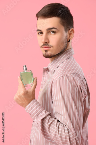 Handsome man with perfume o...