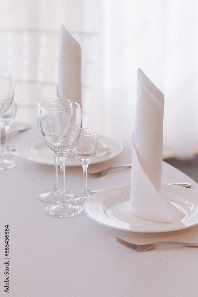 Three empty glasses for alcoholic beverages of vodka, wine and champagne are on the table. High quality photo